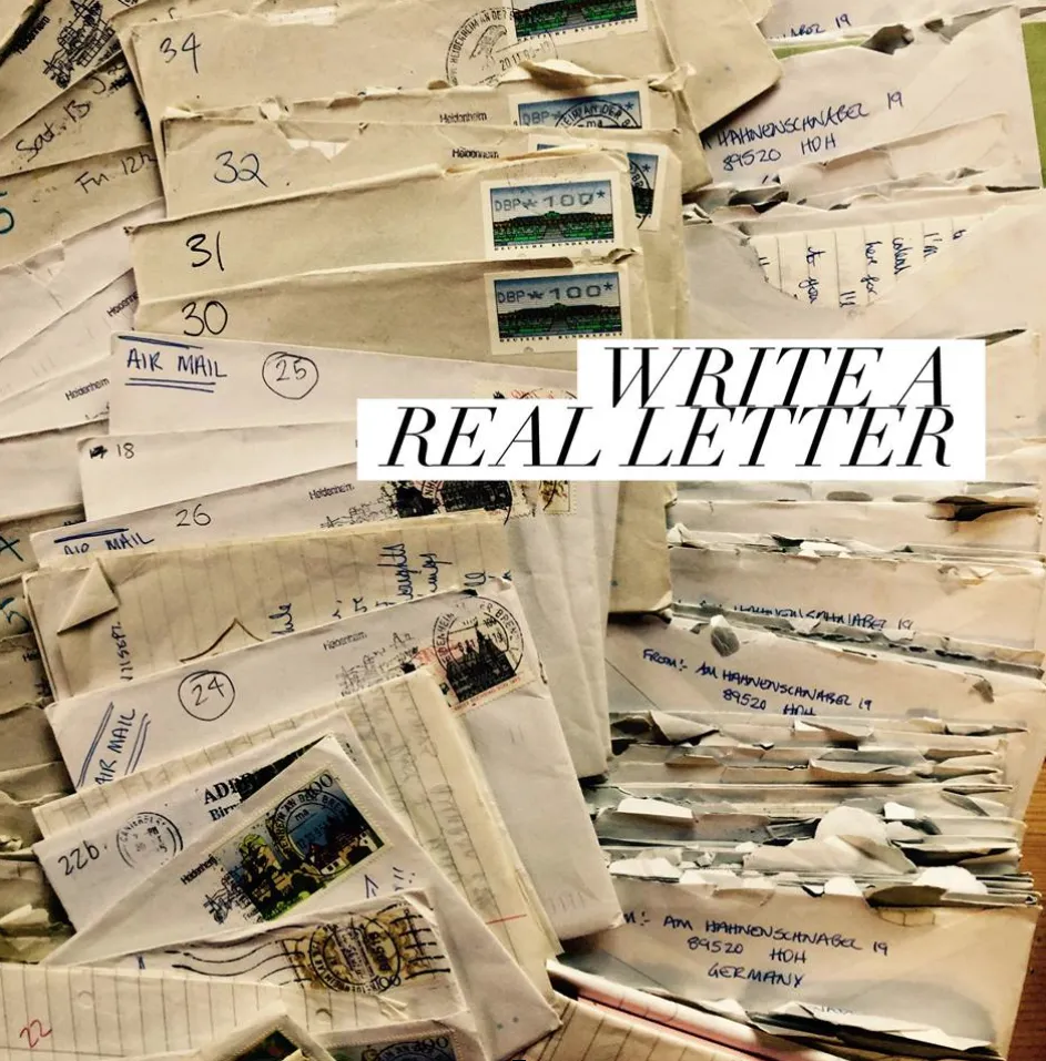 A pile of old handwritten letters with the words Write a real letter