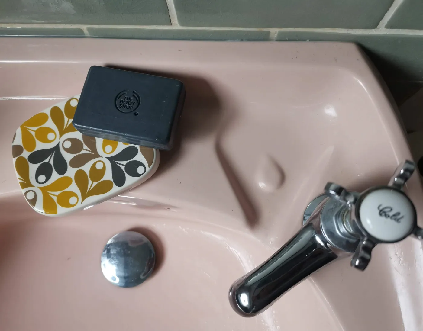 Bars of soap on a pink sink